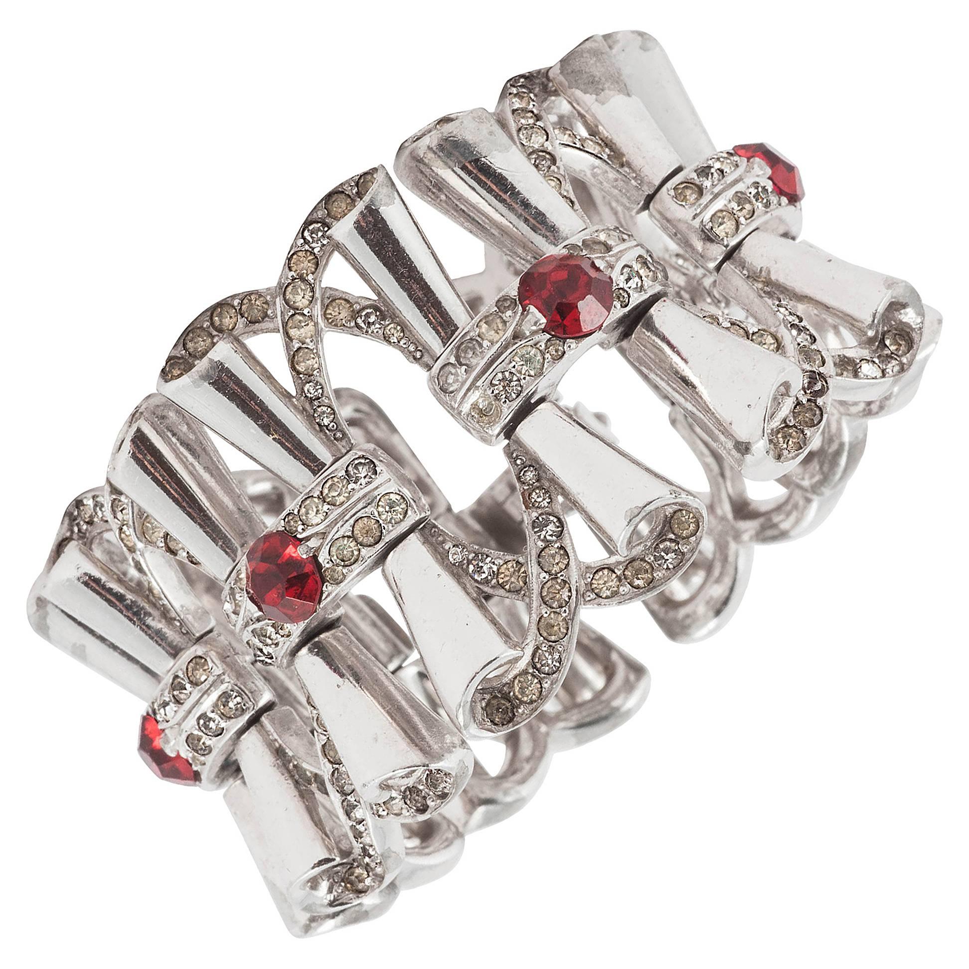 Fluid rhodium plated cocktail bracelet with clear and red paste accents, 1950s