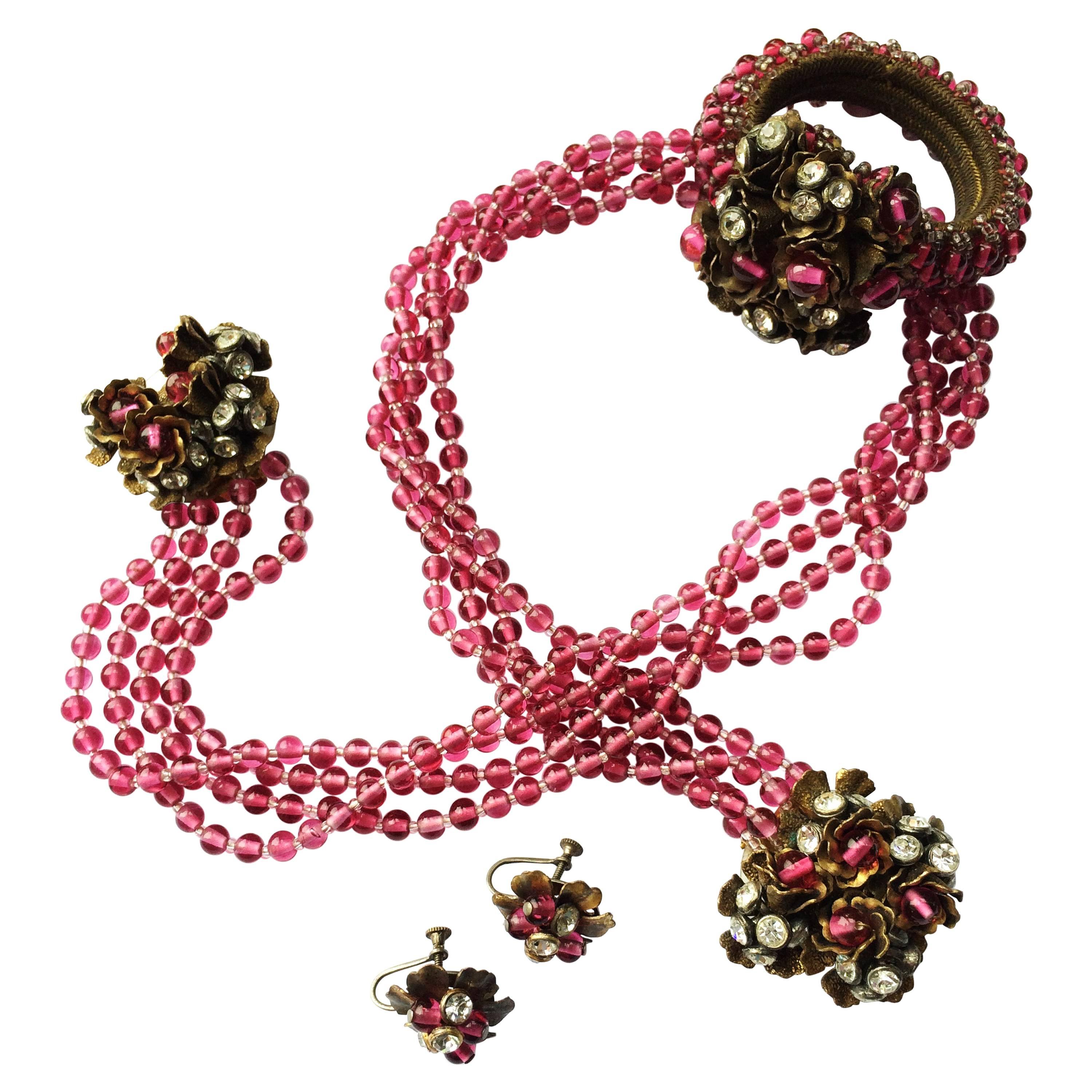 A cranberry glass and paste wrap around parure, Miriam Haskell, USA, 1930s. For Sale