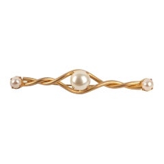Lange Chanel-Brosche aus vergoldetem Metall mit drei Perlen-Cabochons