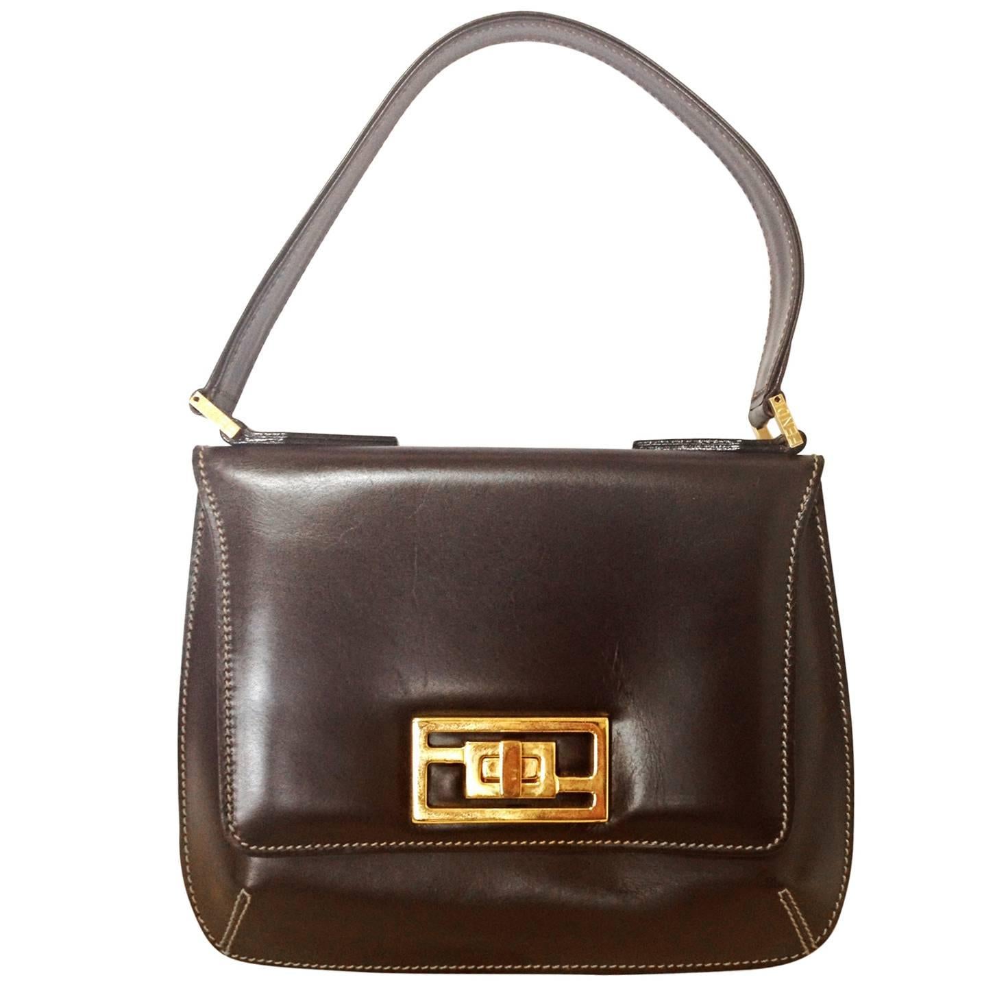 Vintage FENDI genuine dark brown leather handbag with golden FF logo at closure. For Sale