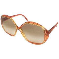 Vintage COBRA large, round oversized orange frame sunglasses with grey shades.