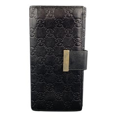 Portefeuille de chèques en cuir noir avec monogramme embossé de Gucci