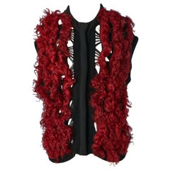 Black knit sleeveless vest with red curly furs appliqué Paolo Errico 