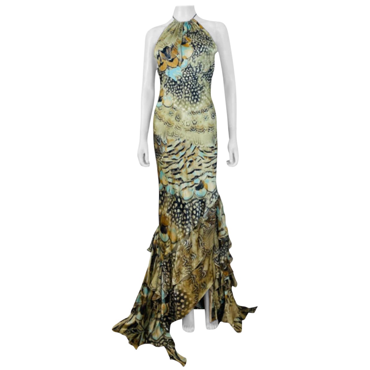 S/S 2004 Roberto Cavalli Silk Dress Gown
Incredible multi feather print silk fabric with gold glitter acents
Halter neckline with with long ties with an iridescent beads and feathers at each end
Keyhole cut at at the bodice
Form fitted style with