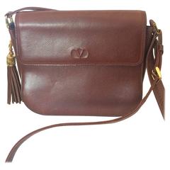 Vintage Valentino Garavani dark brown leather shoulder bag with tassel charm.