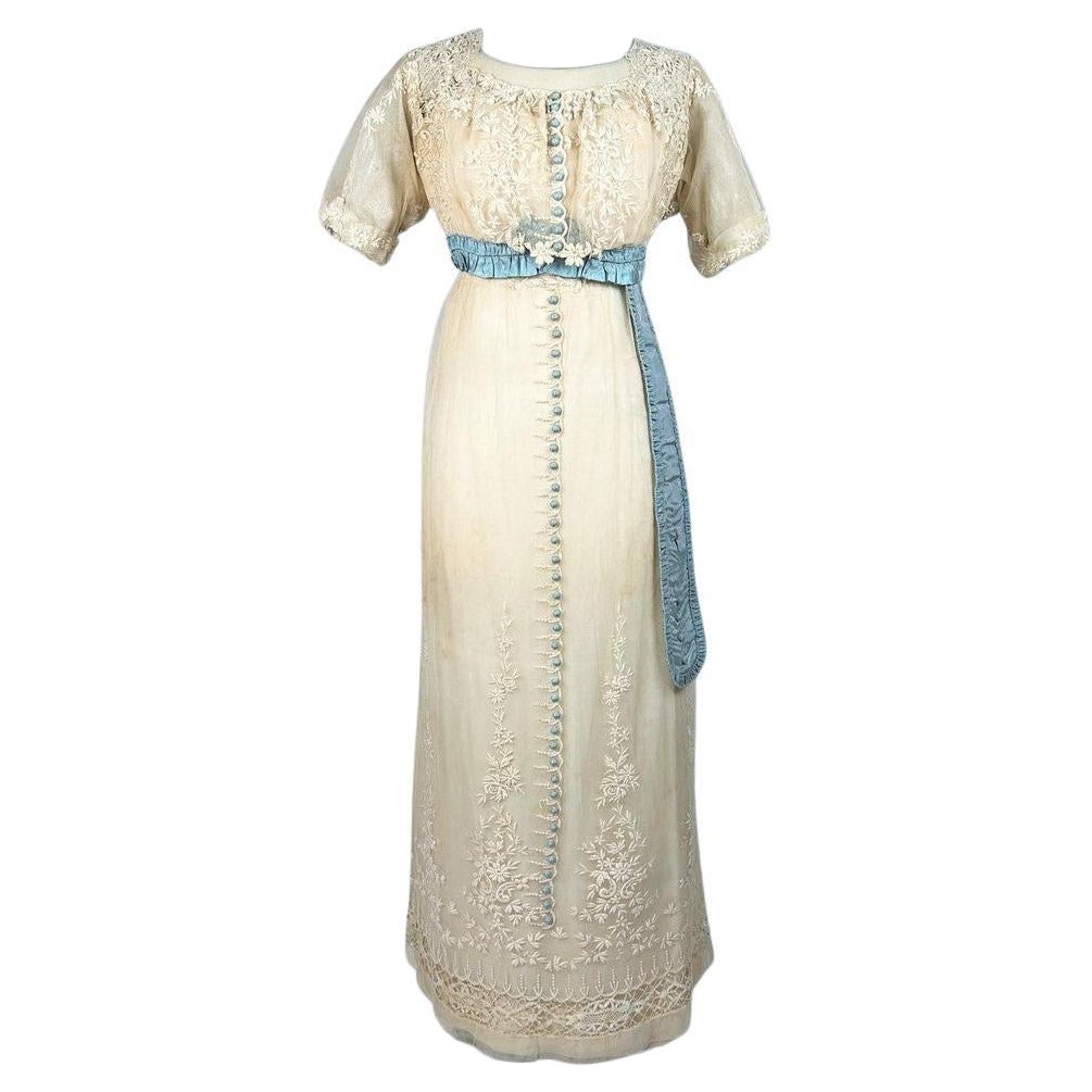 A neo-classical dress in embroidered cotton tulle and taffeta -France Circa 1910 For Sale