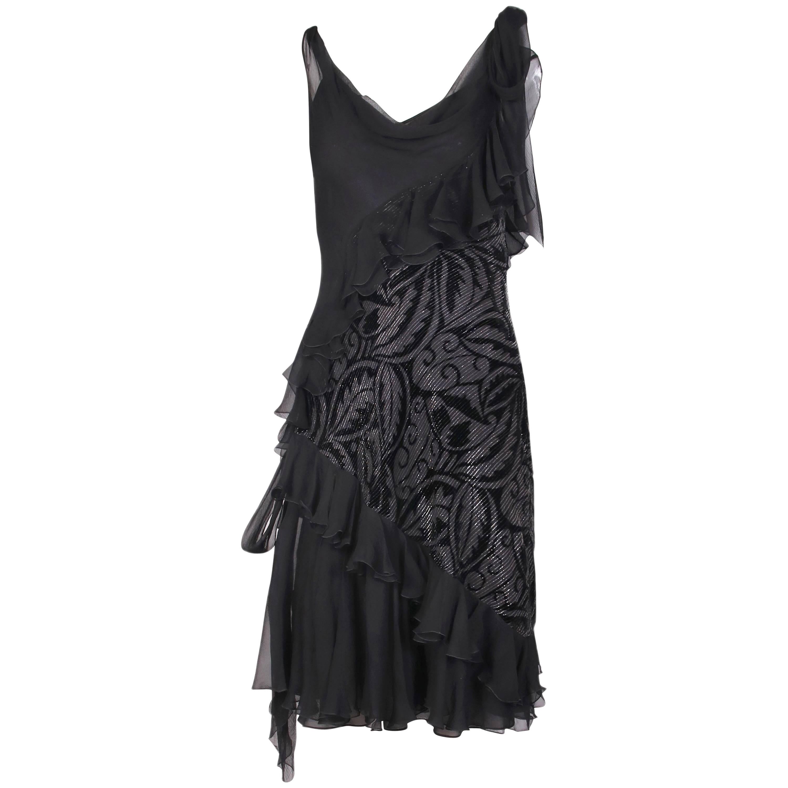 Vintage John Galliano bias cut black silk and silver lurex threaded cut velvet cocktail dress with cowl neckline, diagonal ruffles and long silk ties at a single shoulder and its opposite hip. Comes with a silk slip underneath. In excellent