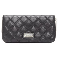 Vintage CHANEL Paris New York black quilted leather silver logo long zip wallet