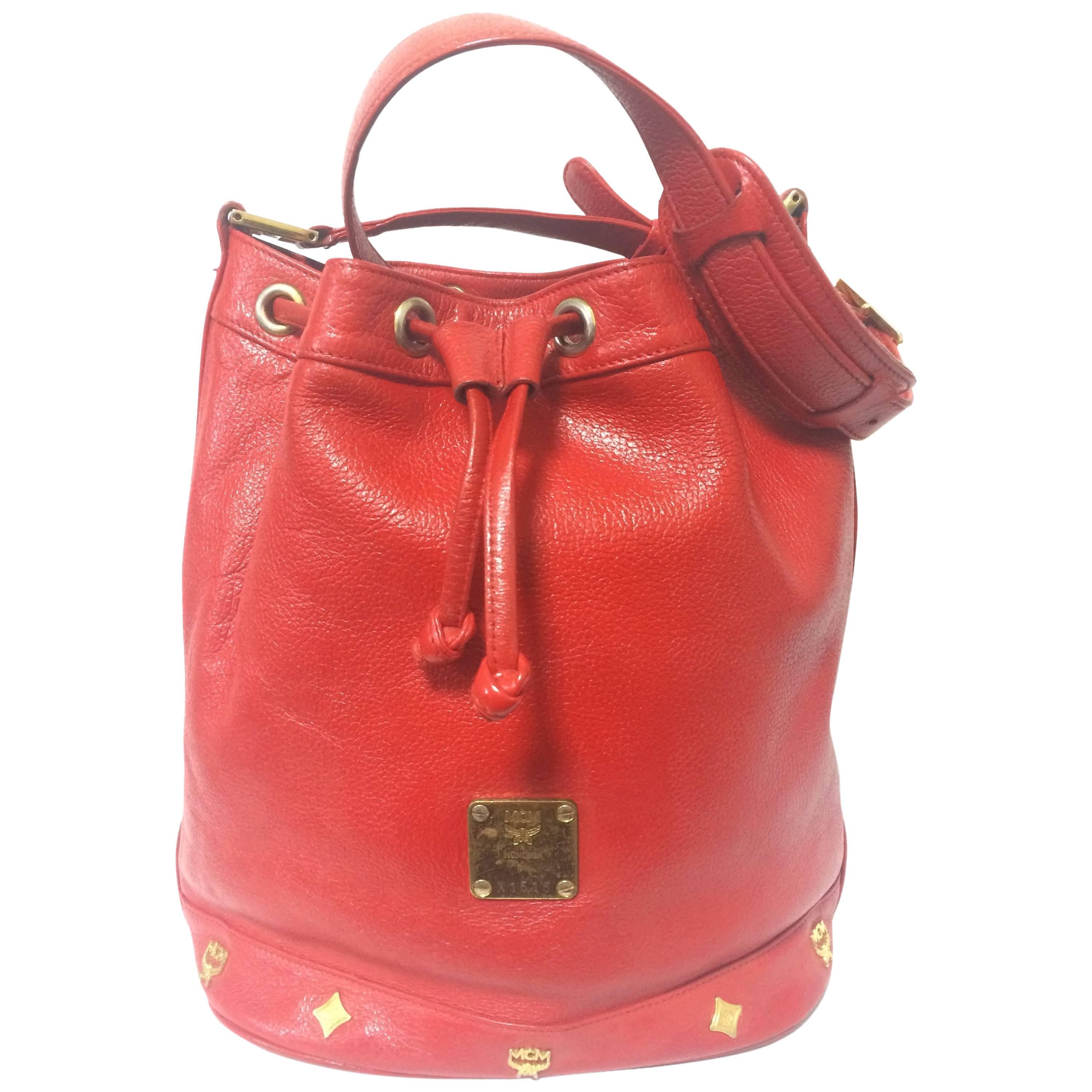Vintage MCM genuine leather red hobo bucket shoulder bag with gold tone motifs. For Sale