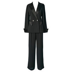 Black backless Tudexo suit in polyester crêpe and rhinestone buttons CACHÉ 
