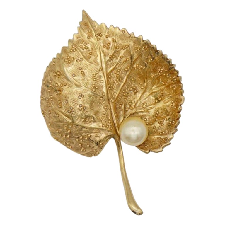 Christian Dior 1980s Vintage Textured Vivid Wave Leaf Round Pearl Brooch, Gold Tone

Very excellent condition. Very light scratches at back. Safety-catch pin closure. 100% genuine.

A unique piece. This is gold plated stylised brooch. 

Size: 4.6 cm