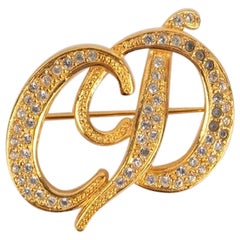 Christian Dior Broche dorée avec strasss
