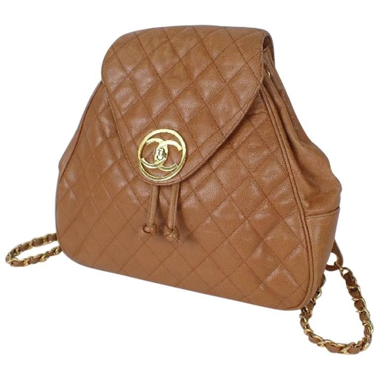 Vintage CHANEL quilted brown caviar leather backpack with gold chain straps.
