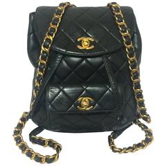 Vintage CHANEL quilted black lamb leather backpack with gold chain and CC.