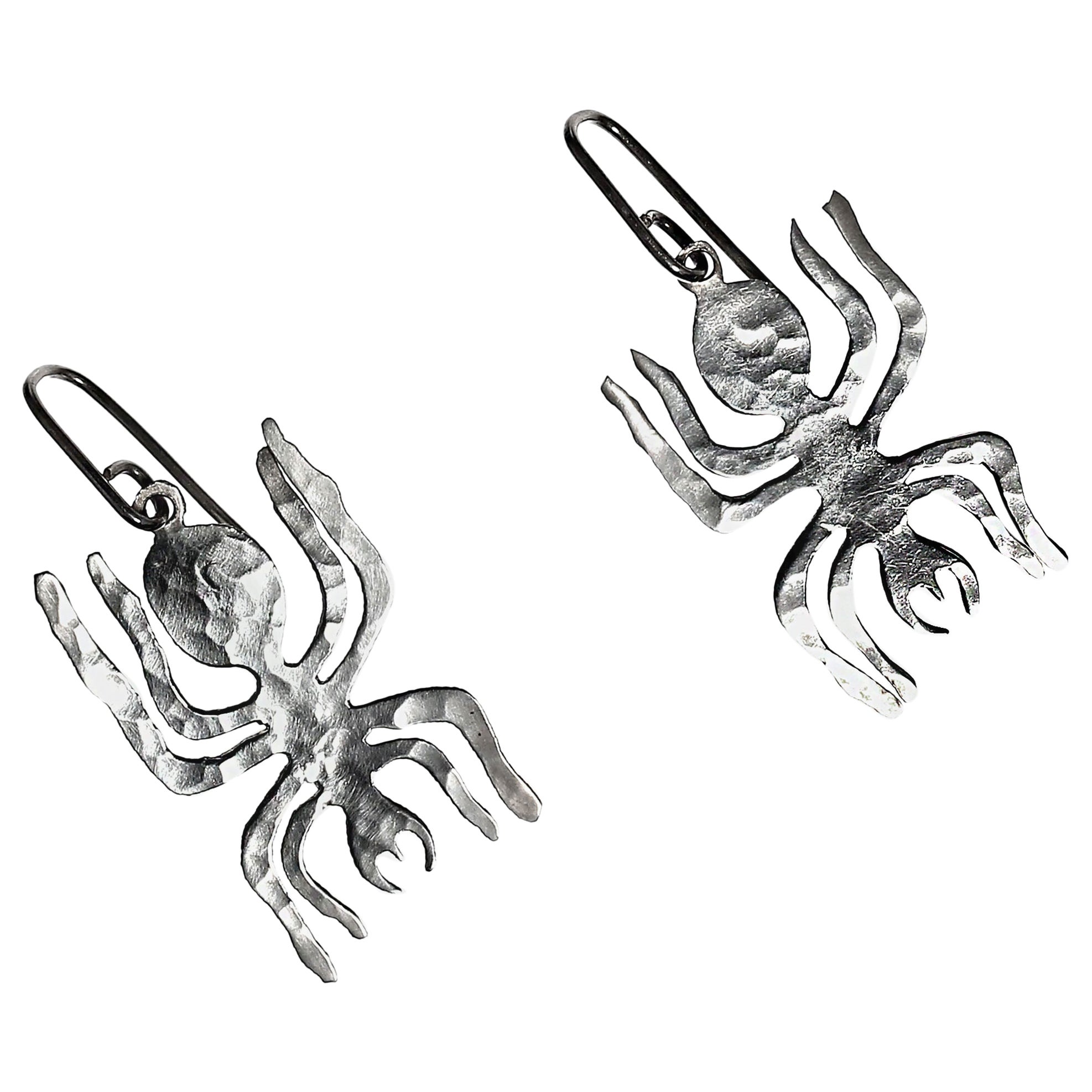 Sterling silver NAZCA line spider earrings. 
World famous Peruvian NAZCA lines come alive in these hammered sterling silver earrings. Handmade earrings in the World-Famous NAZCA Lines. The Nazca Lines are a series of ancient geoglyphs in the Nazca