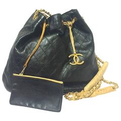 Vintage CHANEL black and beige calf leather hobo bucket shoulder bag with charm.