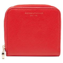 Cartera compacta Aspinal of London de piel roja con cremallera