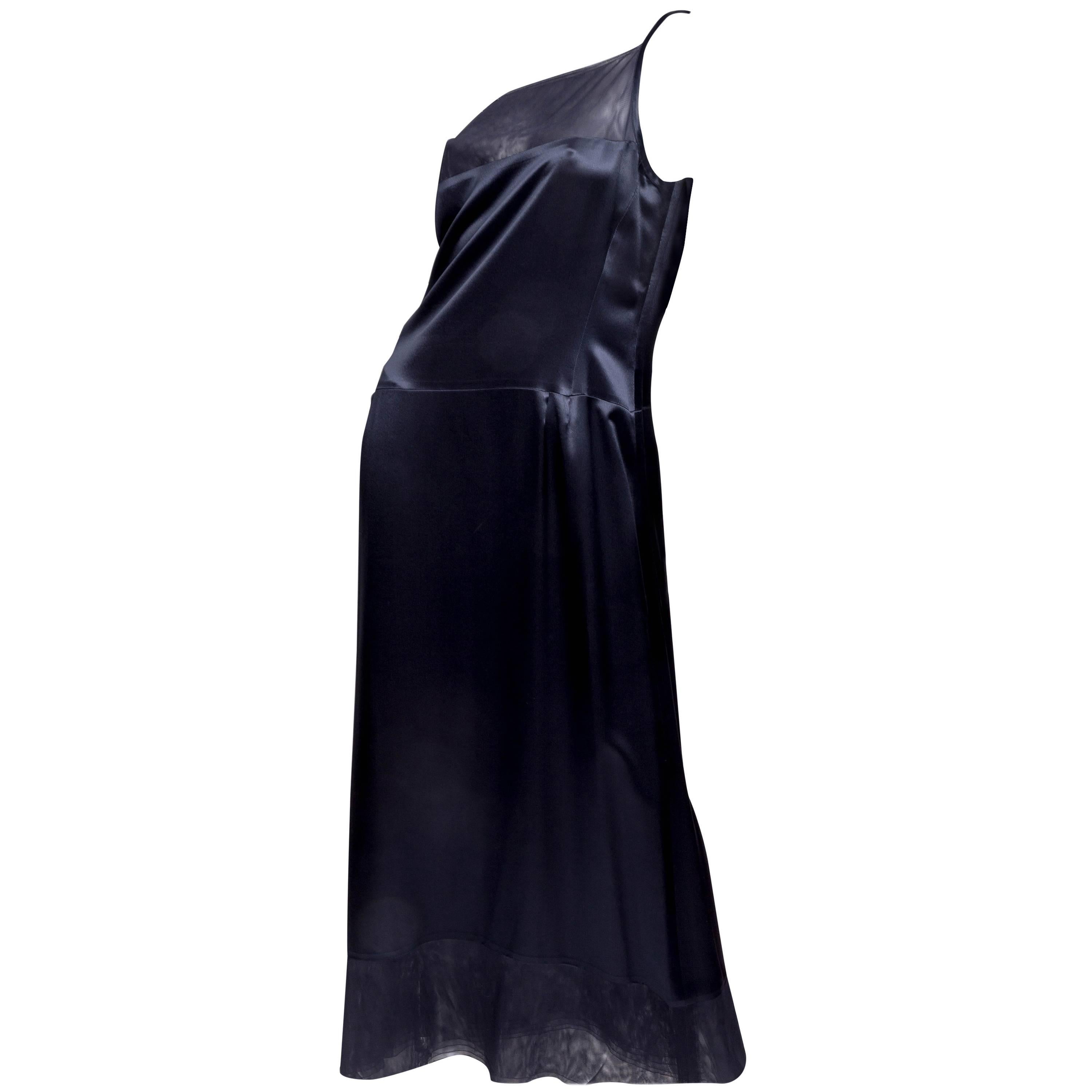 This stunning dress with matching kimono style jacket is the essence of Chanel glamour. Dark blue 100% silk fabric is used for both pieces. This beautifully simple dress has spaghetti straps and is trimmed with sheer tulle at the hem and neck. The
