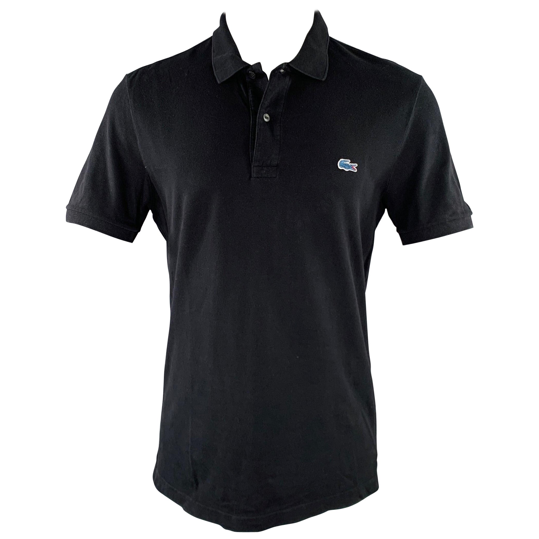 Polo in cotone nero con mezza abbottonatura LACOSTE taglia M