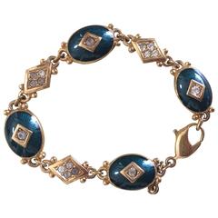 Retro Burberrys golden bracelet with emerald green and diamond shape charms.
