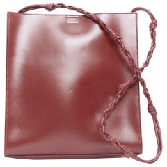 JIL SANDER Tangle burgundy knotted leather strap medium crossbody bag