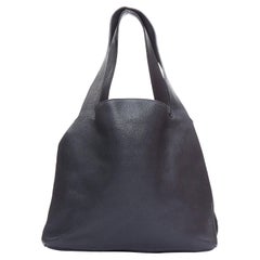 THE ROW - Sac fourre-tout hobo minimal en cuir noir grainé et clous dorés