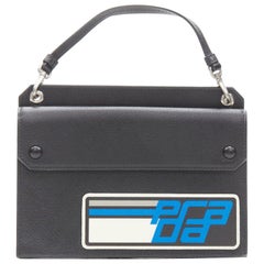 PRADA Racing Graphic Logo black saffiano flap front pocket flat top handle bag