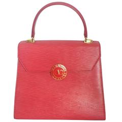 Vintage Valentino Garavani pink red epi leather handbag with round V logo motif.