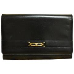 Vintage Celine black calfskin leather clutch bag with iconic golden logo motif.