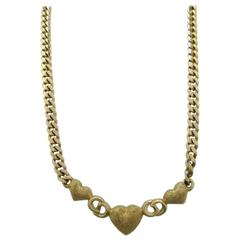 Retro Christian Dior logo and heart motif, golden chain statement necklace.