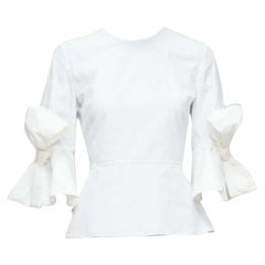 ROKSANDA Kemi Weißes Peplum-Top aus Baumwoll-Poplin mit ausgestellter Schleife und ausgestellten Ärmeln, UK6 XS
