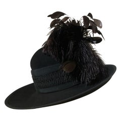 Maison Michel Sombrero Fedora de ala ancha de fieltro de piel negro con cinta trenzada y pluma