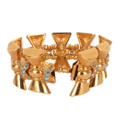 Christian Dior - Bracelet articulé en métal doré avec strass bleus
