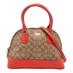 Cartera Cora Dome de Coach en piel y lona revestida naranja/firma