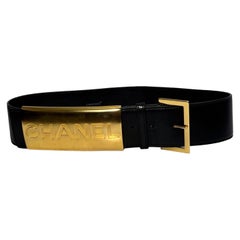 Iconic Chanel logo gold toned hardware bar black leather belt