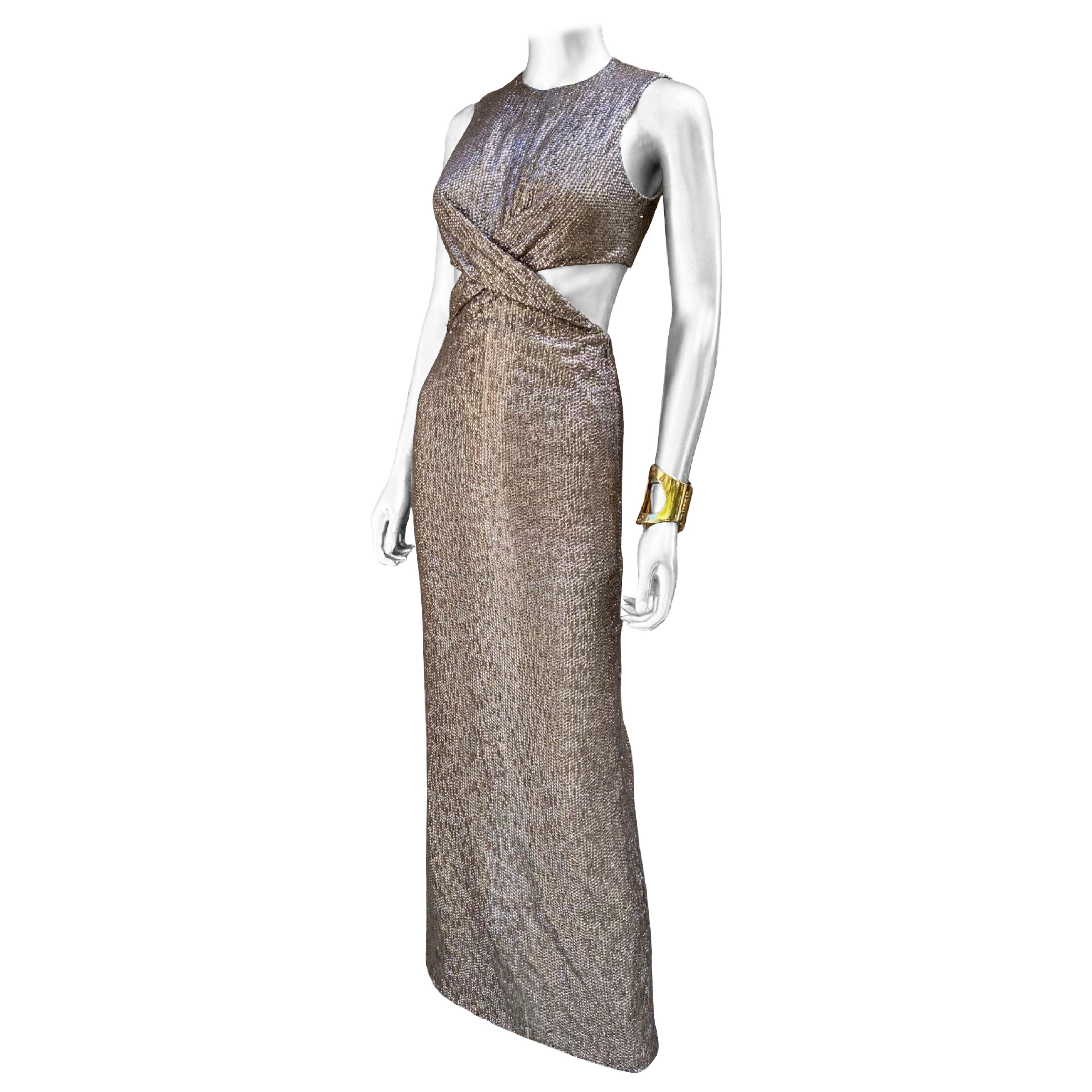 Another chic masterpiece from the dynamic design, duo KaufmanFranco. This dress is equal parts, chic and sexy, made in the most beautiful entirely hand beaded taupe color. This amazing evening dress has a cut out back with a draped front that
