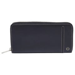 Cartera Tumi de piel negra con cremallera