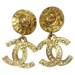 Vintage CHANEL dangling earrings with CC mark and button motif with crystals.