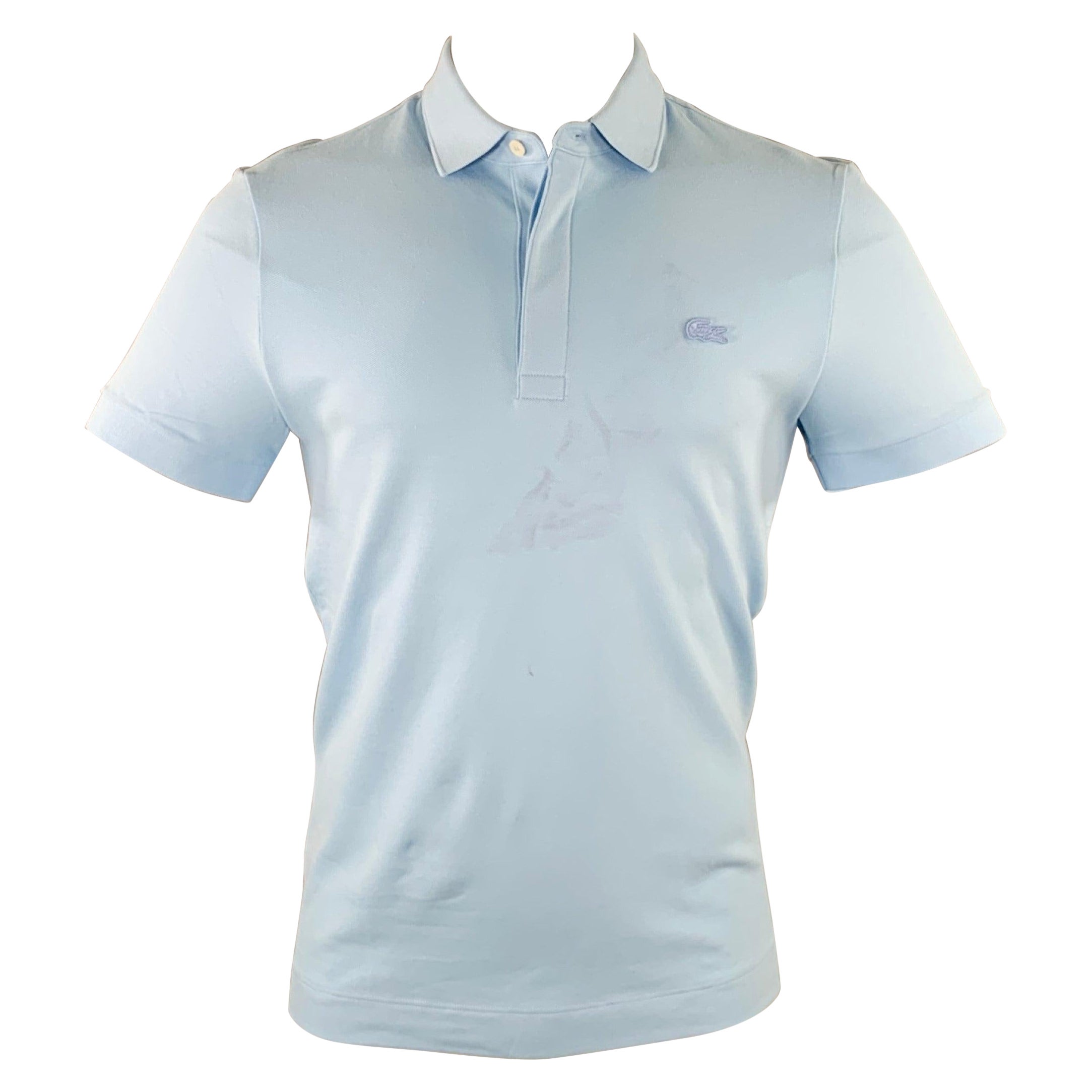 Polo LACOSTE taille S avec broderie bleue en coton mélangé