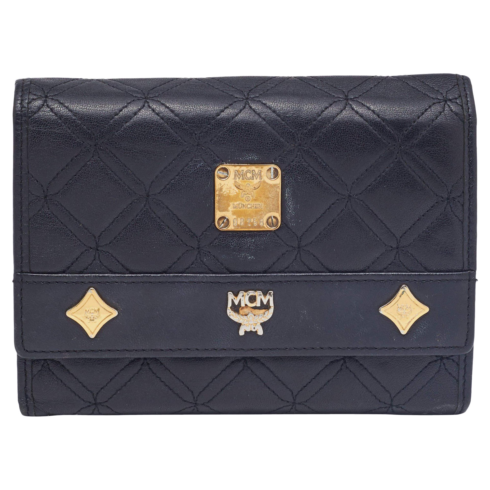 MCM Black Quilted Leather Embellished Flap Compact Wallet For Sale