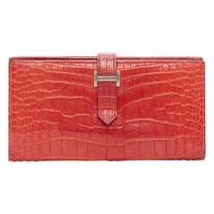 Portafoglio lungo HERMES Bearne rosso in pelle squamata argento con logo H.