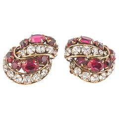 Vintage Elegant ruby/clear paste and gilt stylised 'knot' earrings by Iradj Moini, 1990s