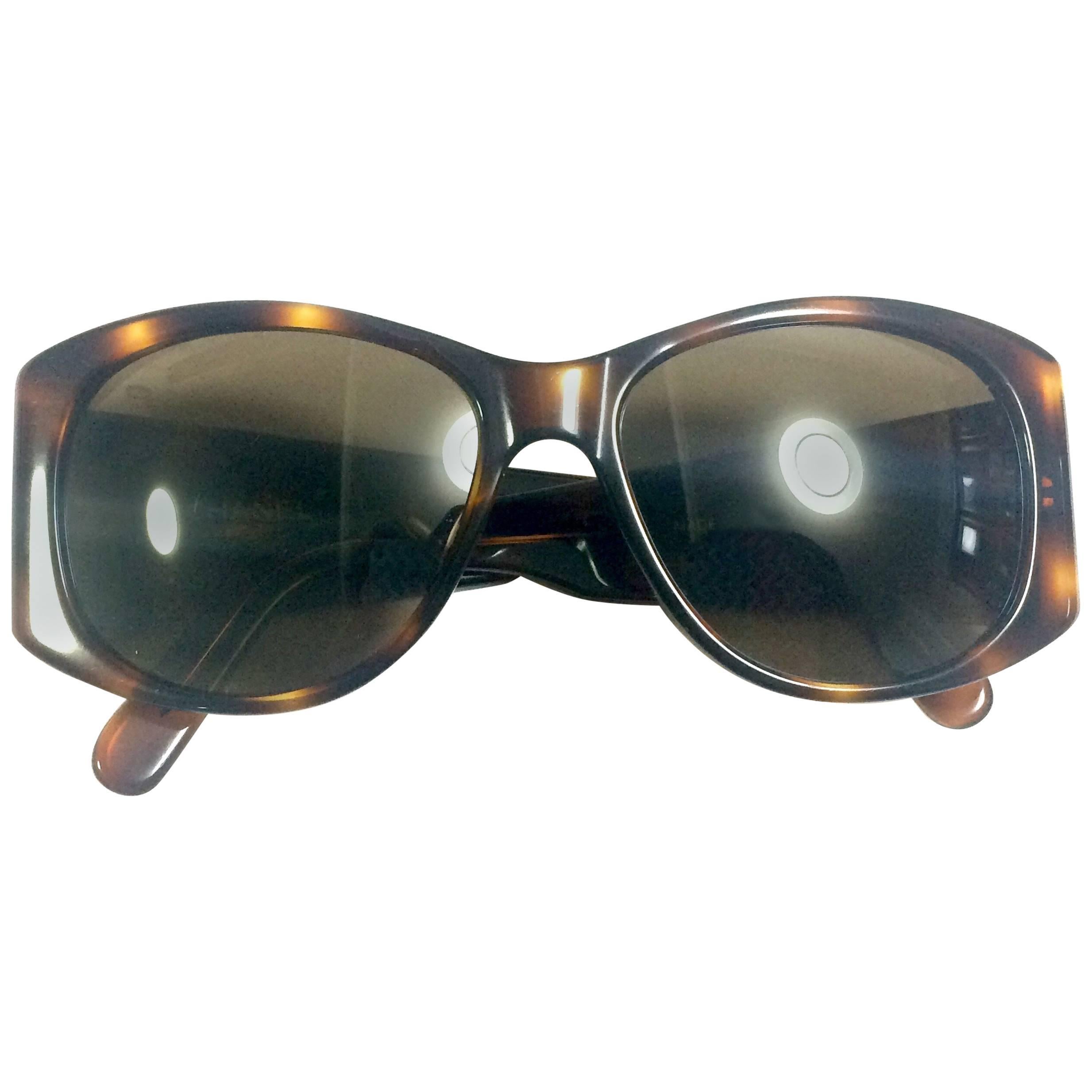 Vintage CHANEL brown frame sunglasses with large CC charms at sides. Classic. For Sale