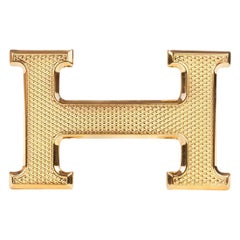 Boucle de ceinture "Guillochée" Hermès neuve en métal doré brillant