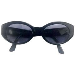 Vintage CHANEL black oval frame sunglasses with golden CC motifs at sides. Mod