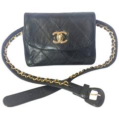 Vintage CHANEL black leather waist purse, fanny bag with golden chain belt.
