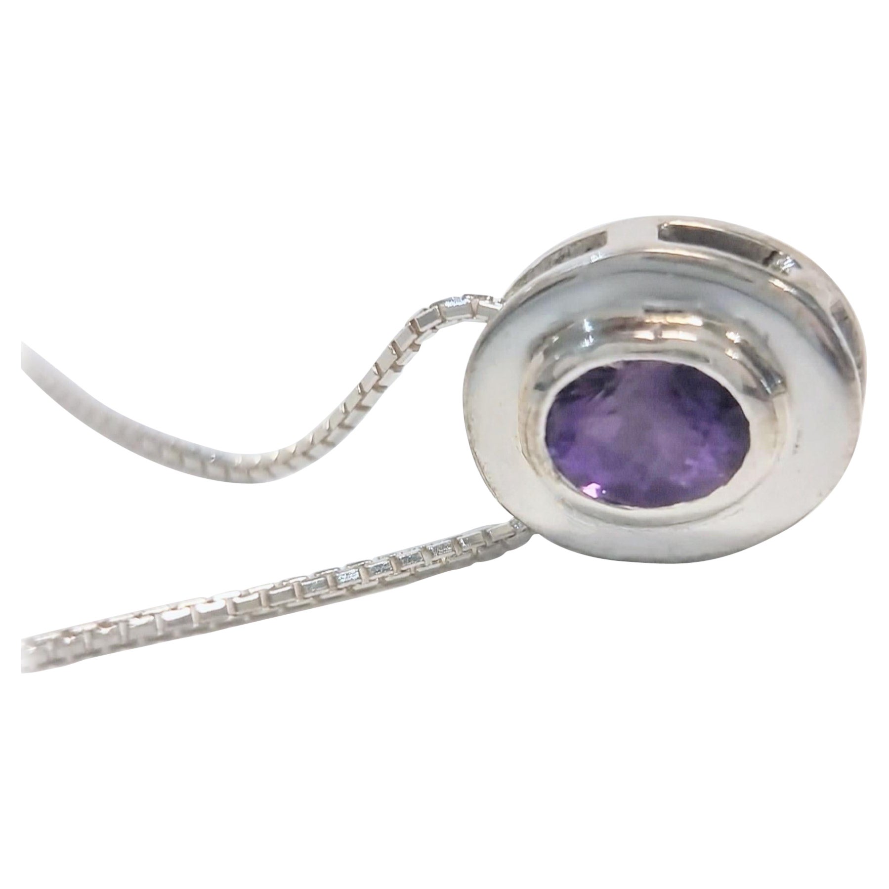 Oval-Cut Amethyst Pendant Necklace in Sterling Silver

This pendant necklace is distinguished by its 9x7mm oval-cut amethyst, a gemstone renowned for its vivid violet hue and natural translucency. The amethyst is bezel-set within a minimalist