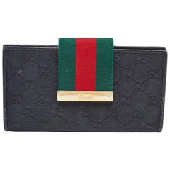 Portafoglio con patta in tela e pelle GG nero di Gucci