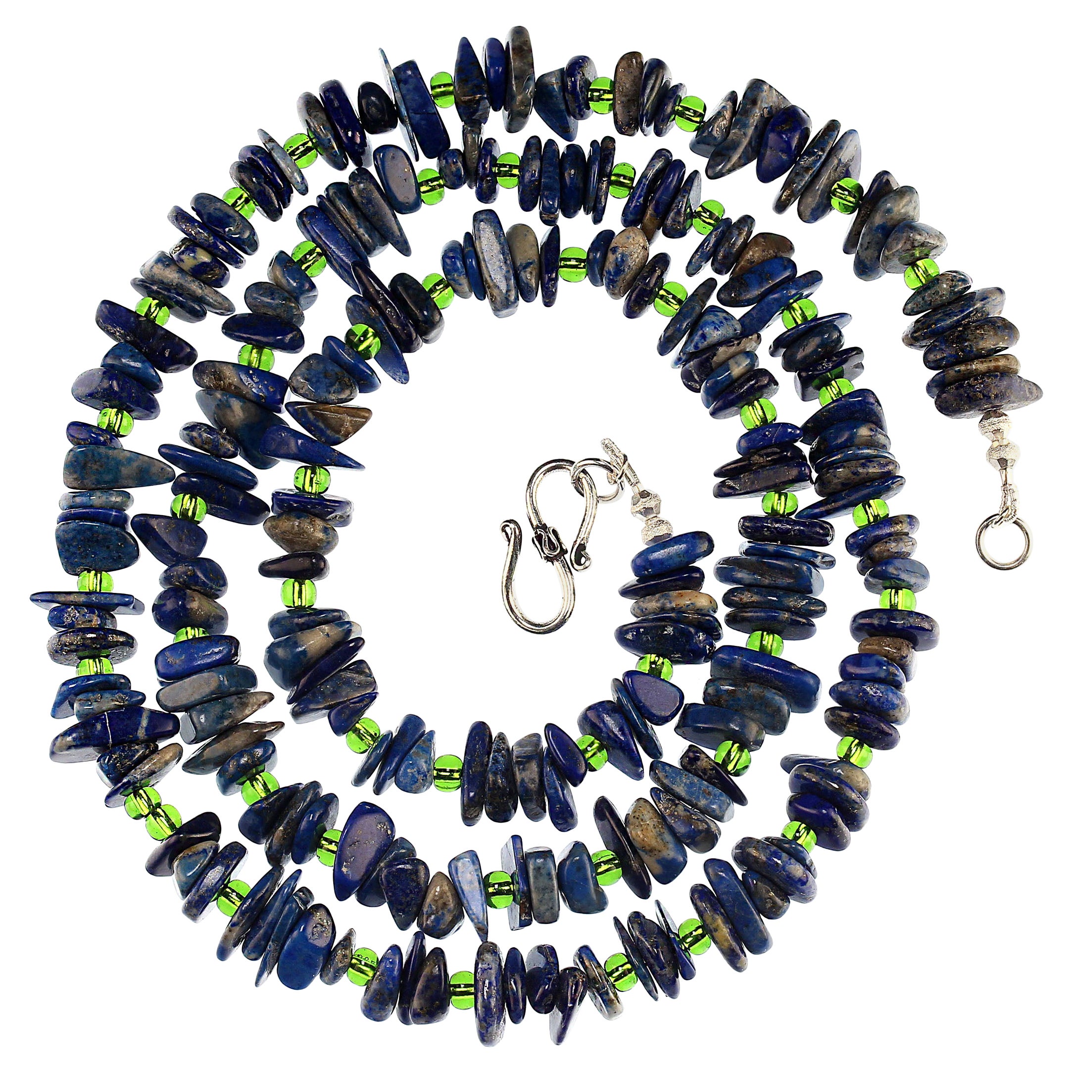 Ce superbe collier présente une combinaison frappante d'éclats de lapis-lazuli bleu naturel, soigneusement polis pour une finition lisse et éclatante, associés à des perles de cristal tchèque d'un vert vibrant. Les éclats de lapis-lazuli polis