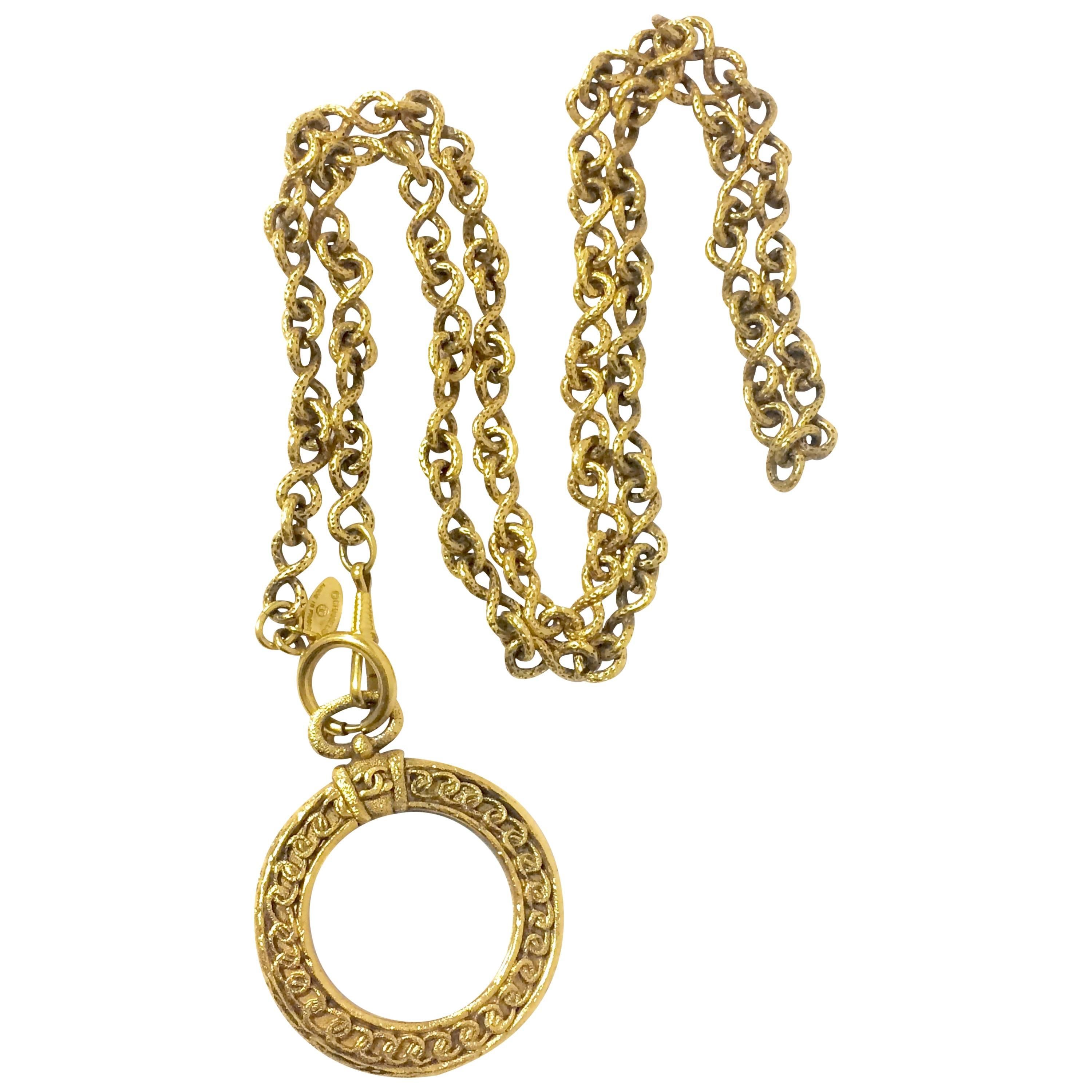 Vintage CHANEL long chain necklace with round glass loupe pendant top and CC.